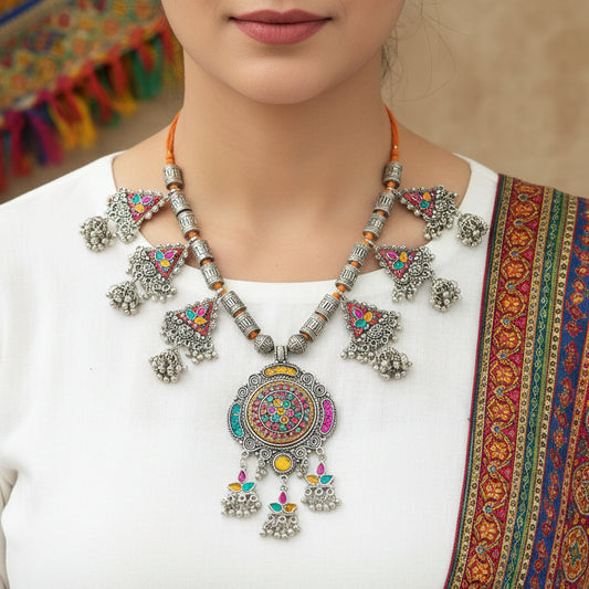 Decorative necklace with colorful pendants on a gray background, featuring the brand 'Saheli'.