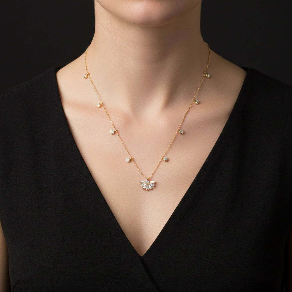 Gold necklace with a fan-shaped pendant on a dark background