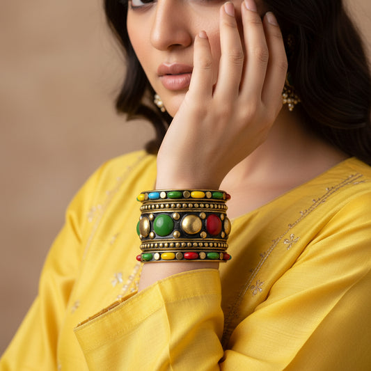 Decorative bracelet with colorful beads on a gray stand against a dark background