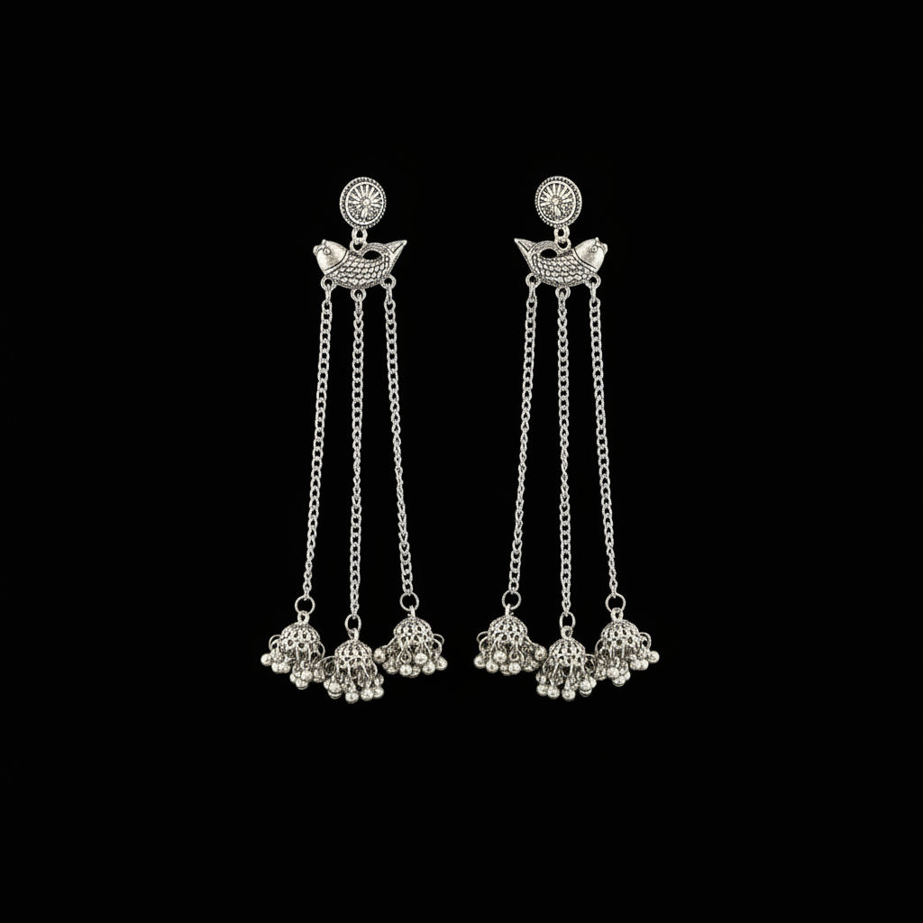 Silver earrings with chain and bead details on a gray background, branded 'SAHELI'.