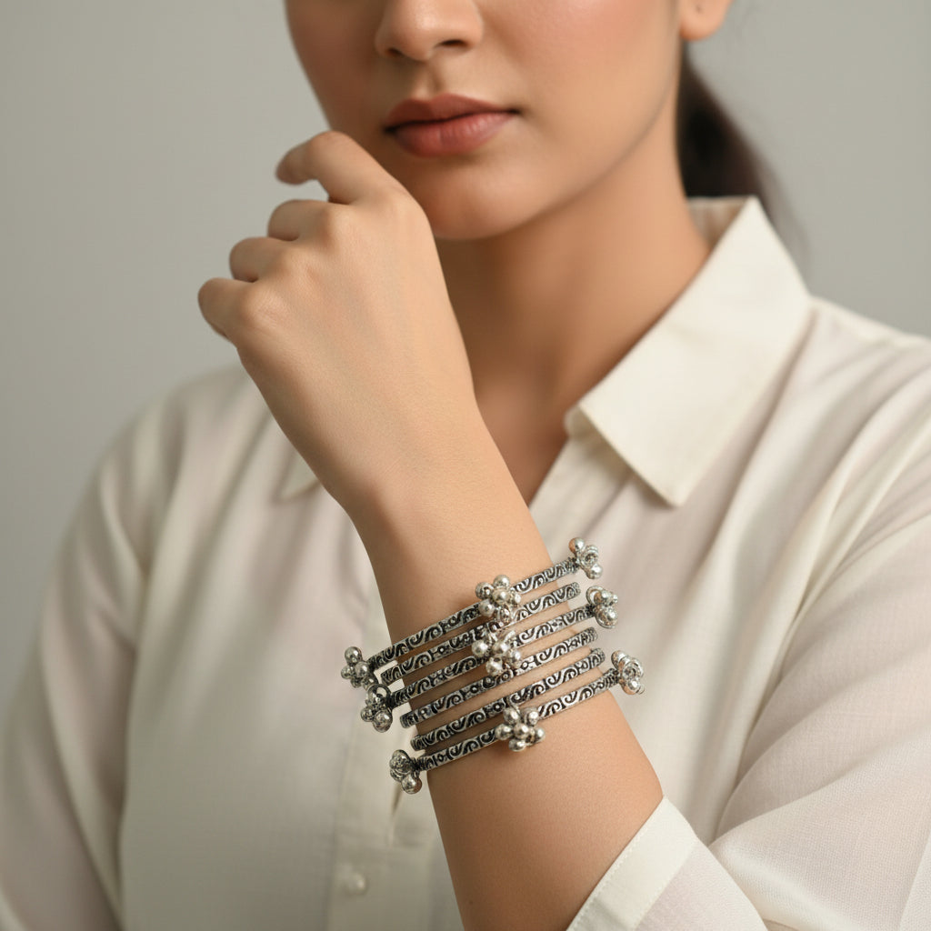 Set of silver hoop earrings on a dark background