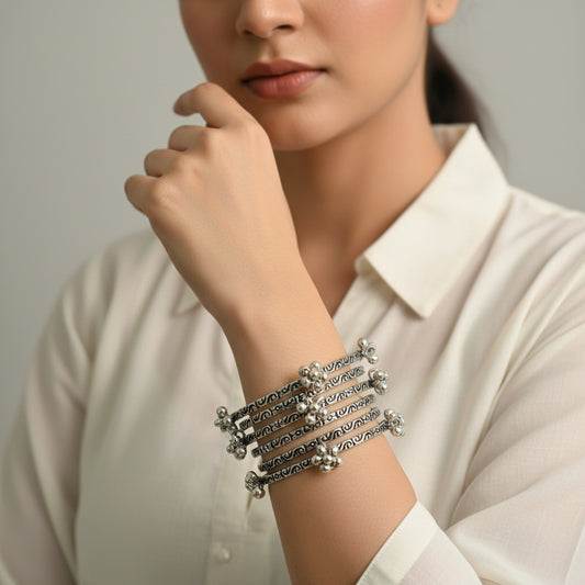Set of silver hoop earrings on a dark background
