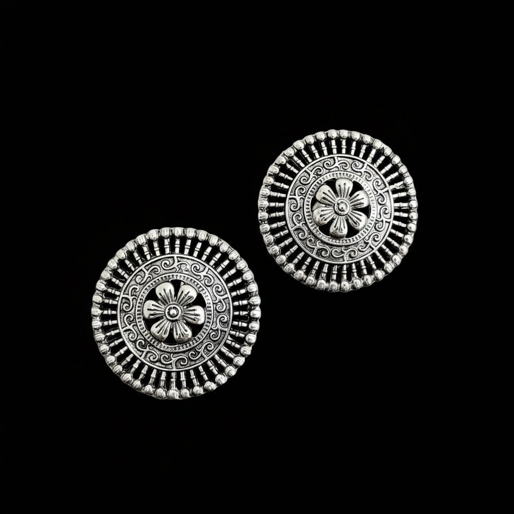 Pair of silver floral earrings on a black background