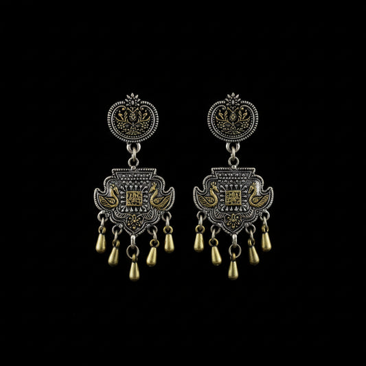 A pair of ornate Indian silver-toned chandelier earrings with gold-toned accents, displayed on a dark gray background with the Sahelli by the Sea Friend brand logo above them.
