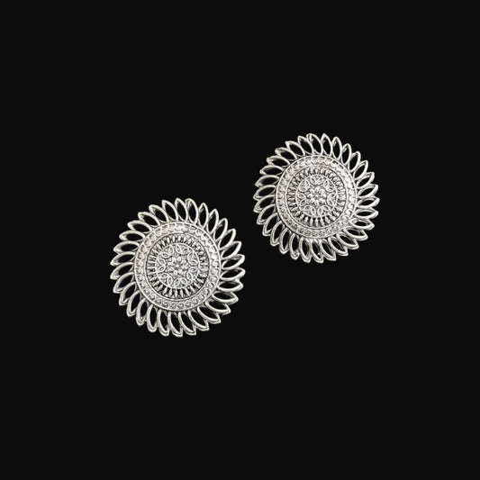 Pair of silver floral earrings on a gray background