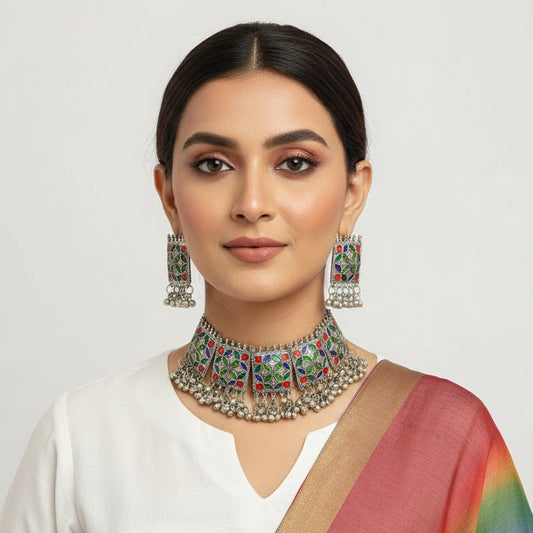 Silver jewelry set with colorful gemstones on a dark background
