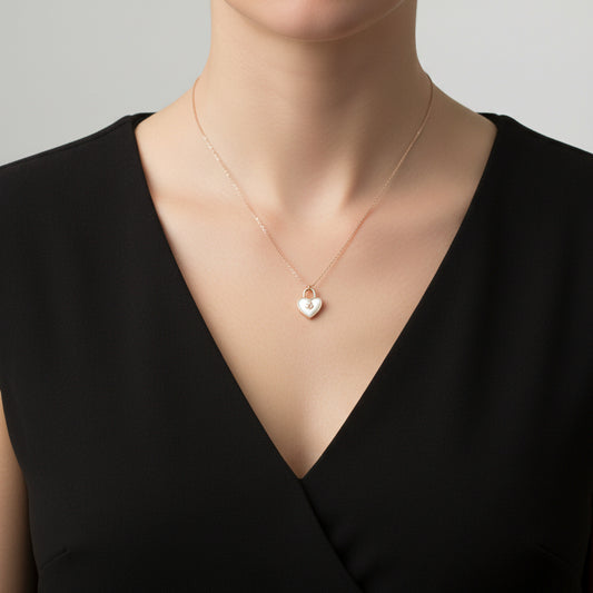 Heart-shaped pendant necklace with 'Saheli' branding on a dark background