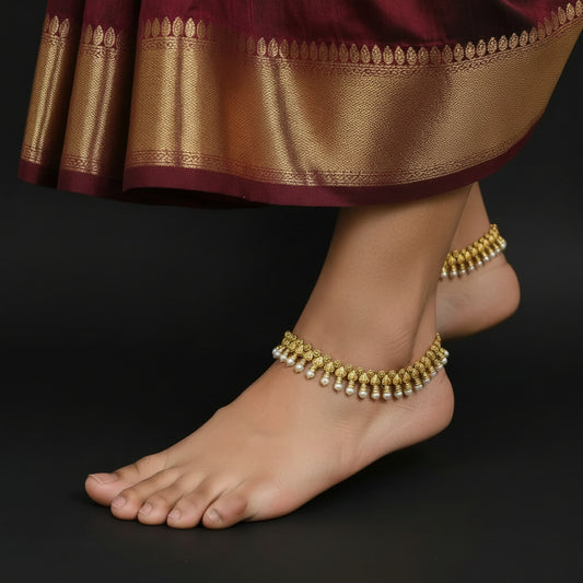 Gold and white beaded necklace on a dark background with 'SAHELI' branding.