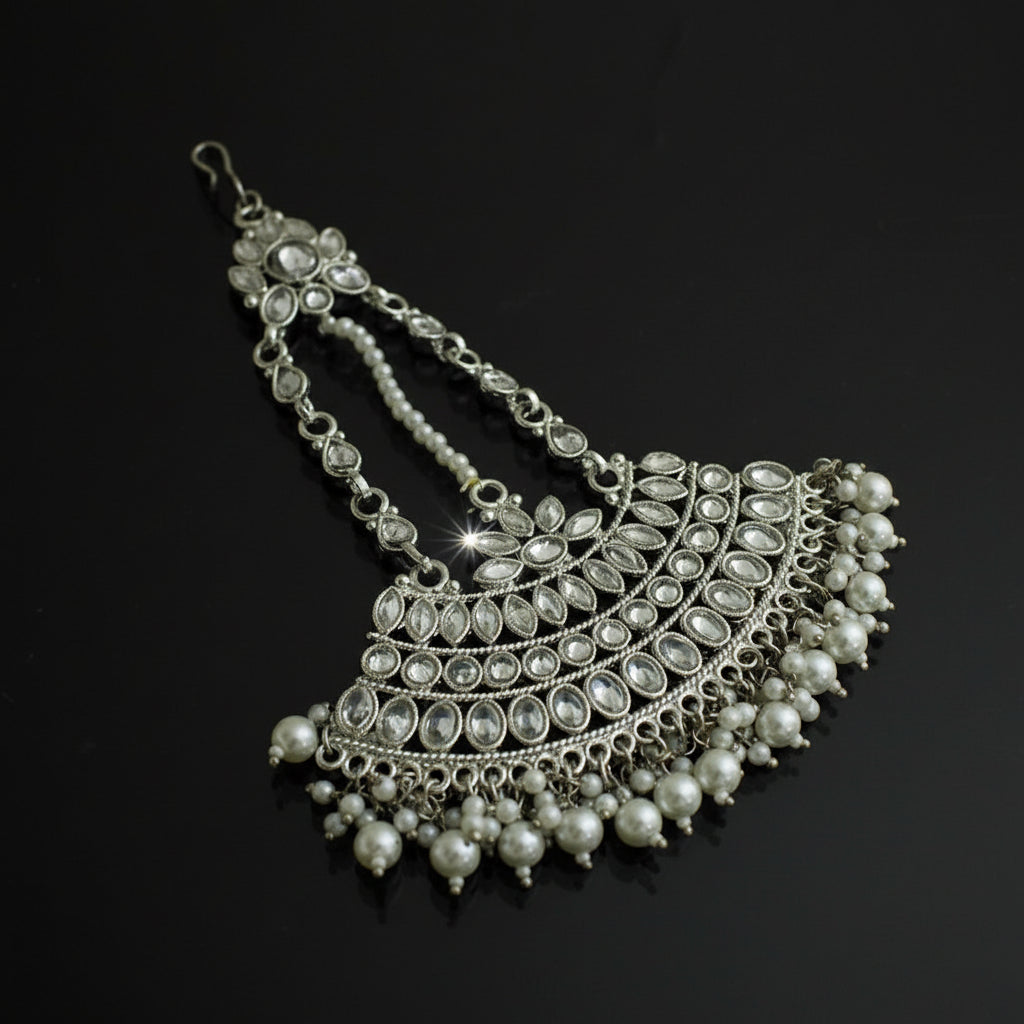 Silver necklace with pearls on a black background