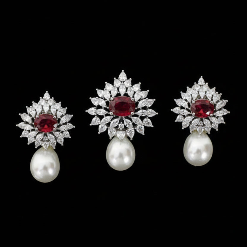 Set of earrings with gemstones and pearls on a black background
