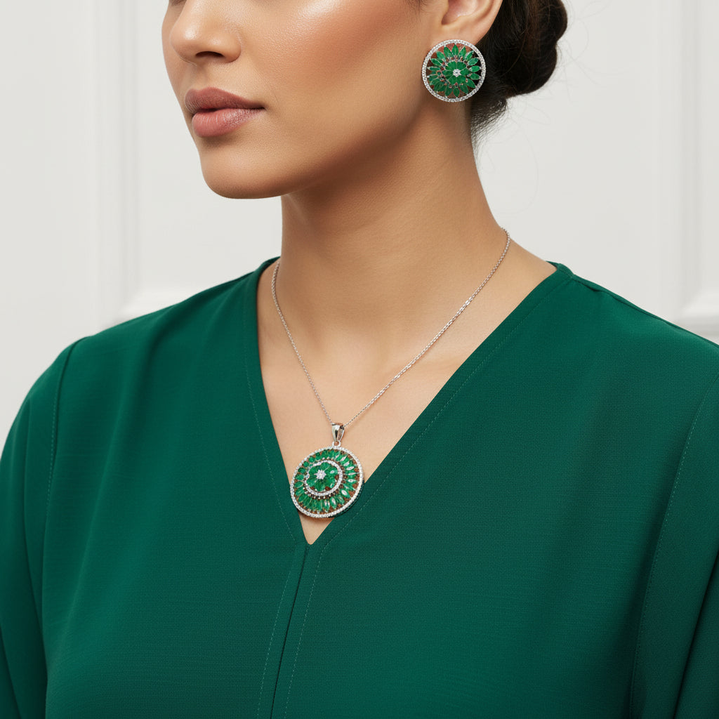 Set of green gemstone earrings and pendant on a dark background