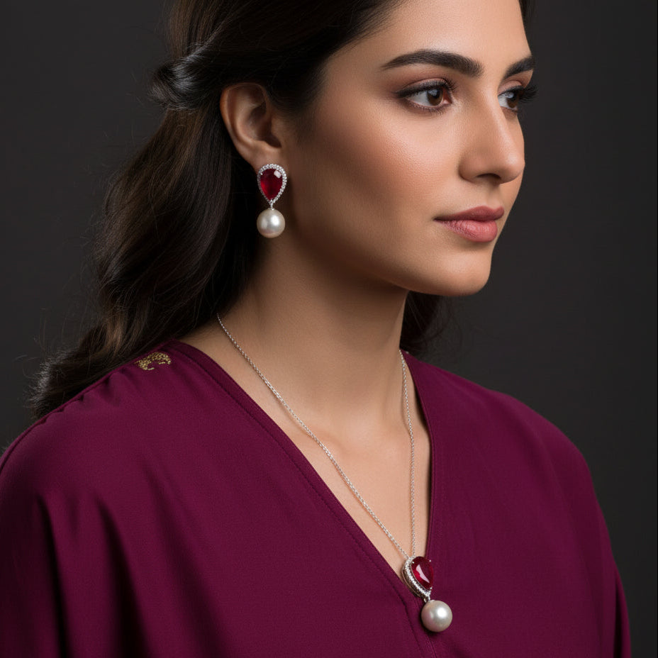 Jewelry set with necklace and earrings on a black background, featuring the brand 'Saheli'.