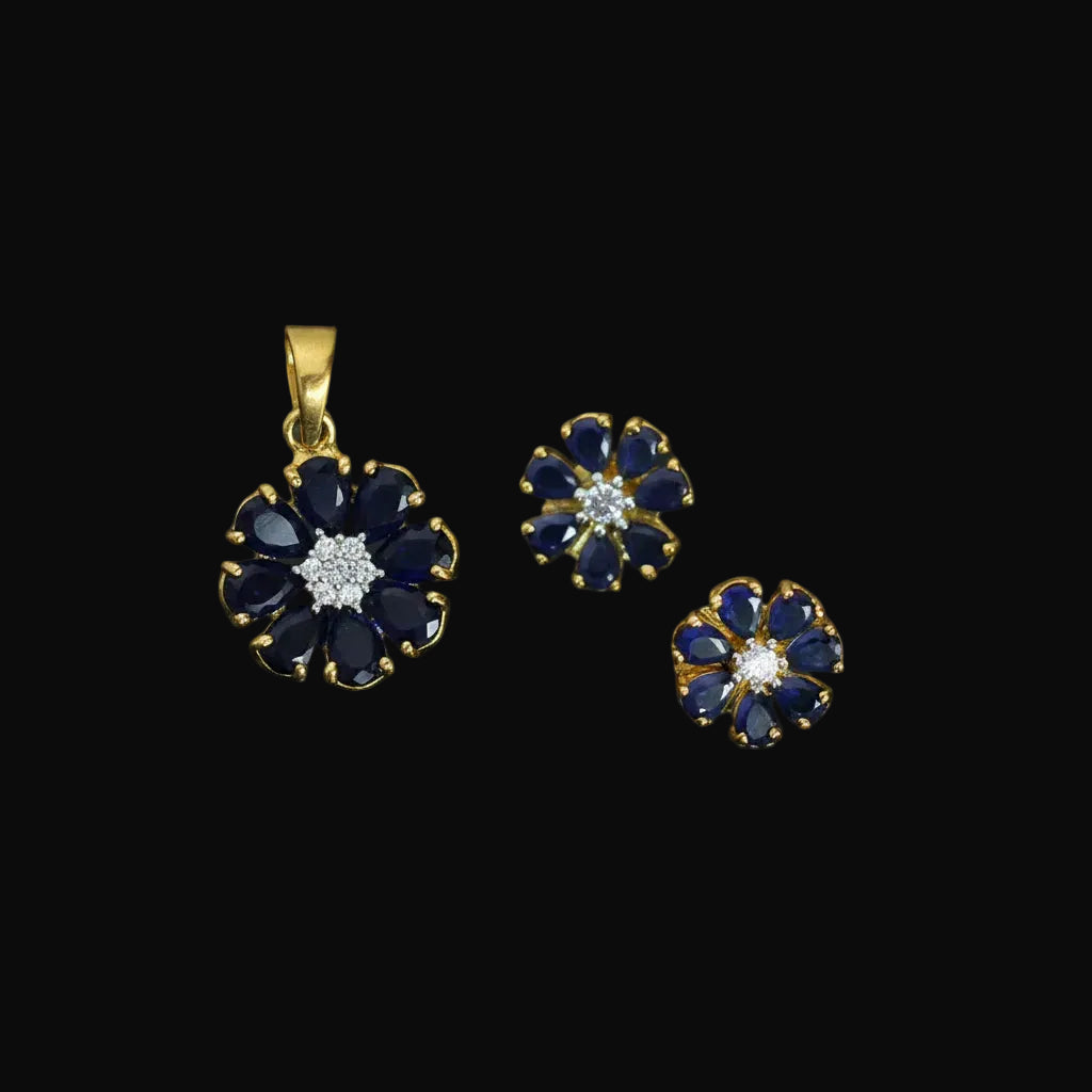Jewelry set with pendant and earrings on a dark background, featuring the brand 'Saheli'.