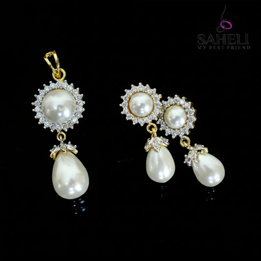 Pearl earrings with gold accents on a dark background, branded 'Saheili'.