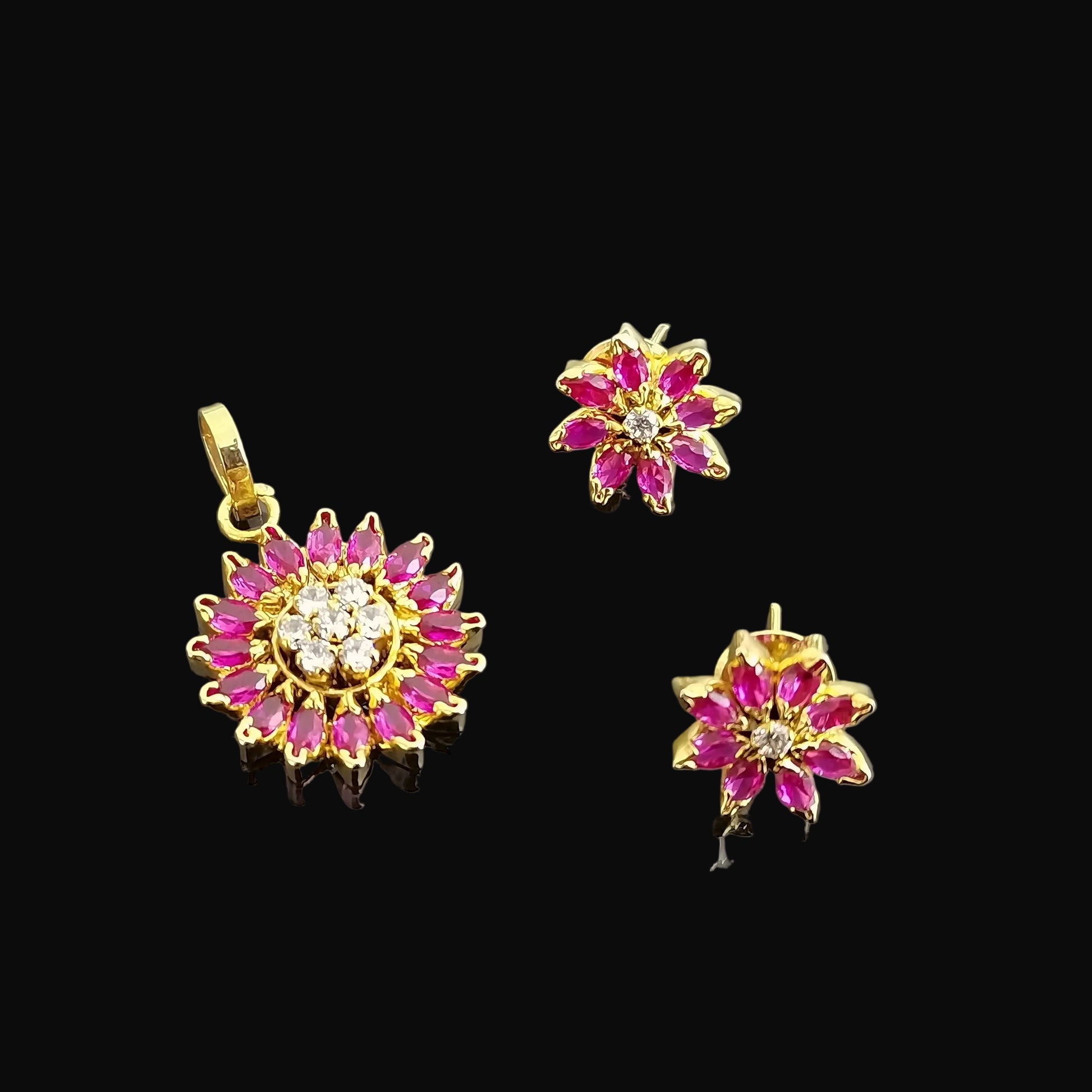 Gold jewelry set with pink gemstones on a gray background, featuring the brand 'SAHELL'.
