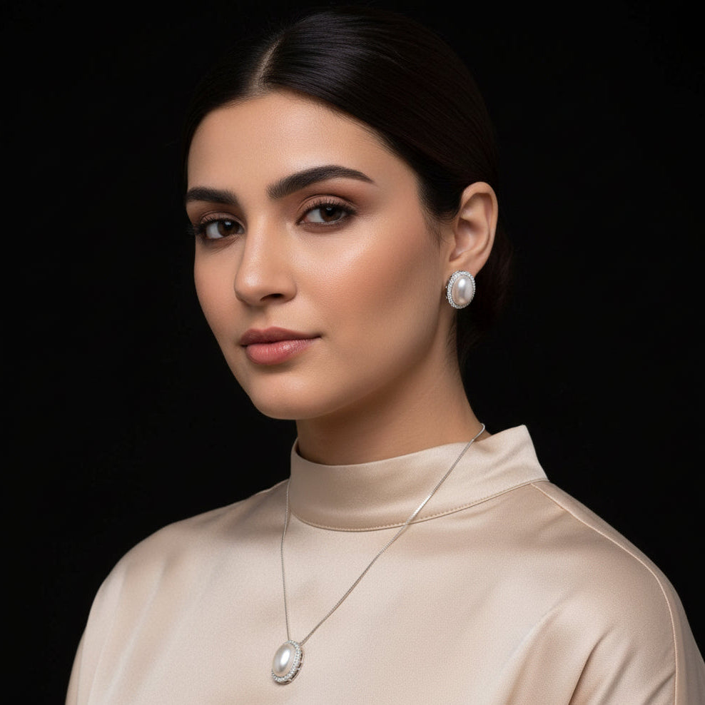 Pearl necklace and earrings set on a black background with 'Saheli' branding.