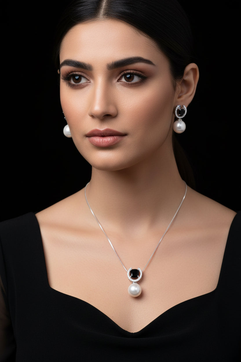 Pearl necklace and earrings set on a black background with 'Sahelli' branding.