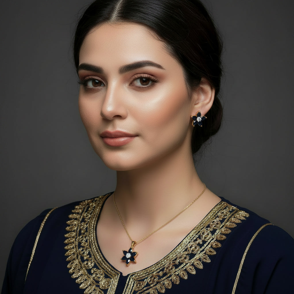 Flower-shaped jewelry set with blue stones and gold accents on a gray background, branded 'Saheli'.