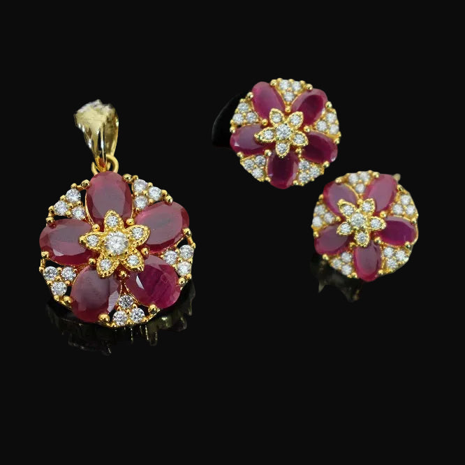 Jewelry set with pendant and earrings on a dark background, featuring the brand 'Saheli'.