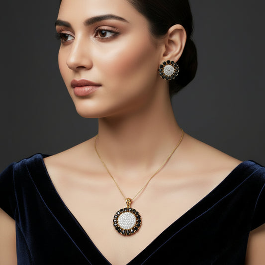 Jewelry set with pendant and earrings on a gray background, featuring the brand 'Saheili'.