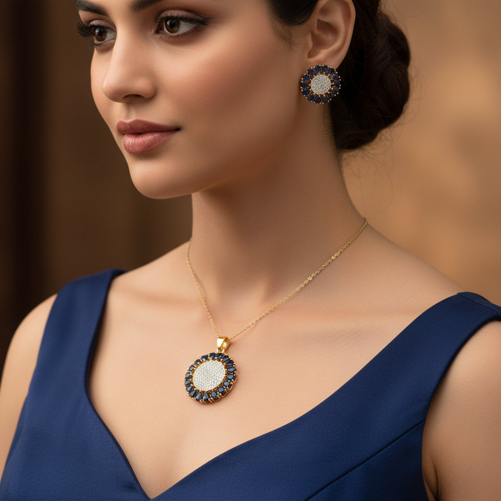 Jewelry set with pendant and earrings on a dark background, featuring the brand 'Saheli'.