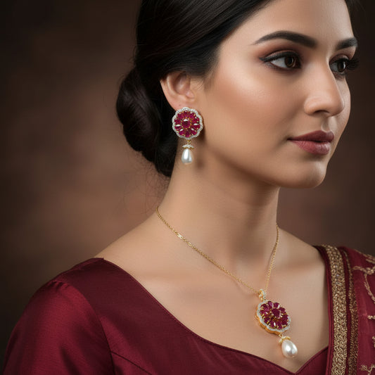 Jewelry set with red gemstones and pearl drops on a dark background, featuring the brand 'Saheli'.
