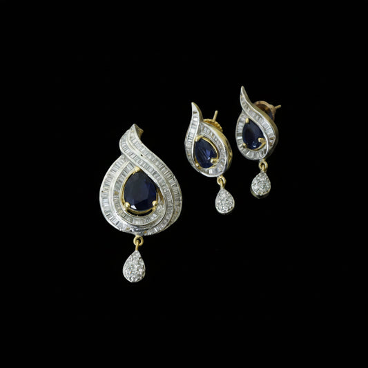 Diamond earrings with black stones on a dark background, branded 'Saheli'.