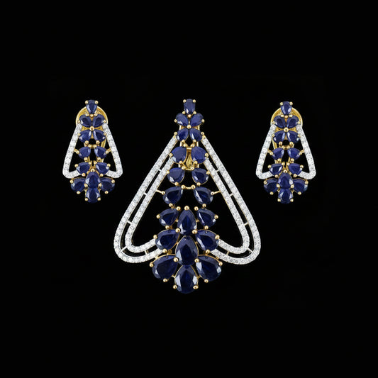 Pair of blue gemstone earrings with gold accents on a gray background, branded 'Saheili'.