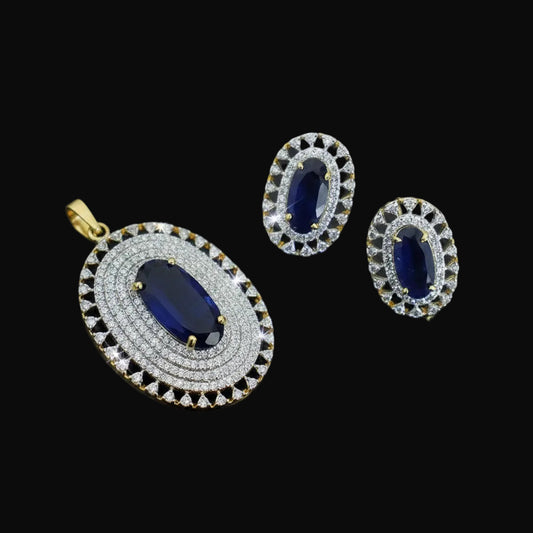 Jewelry set with pendant and earrings featuring blue stones and diamond-like accents on a dark background.