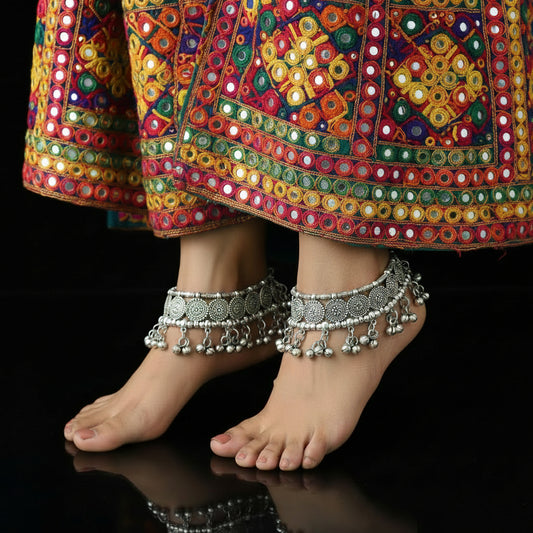 Silver jewelry set including necklace, bracelet, and ring on a dark background with 'SAHELI' branding.