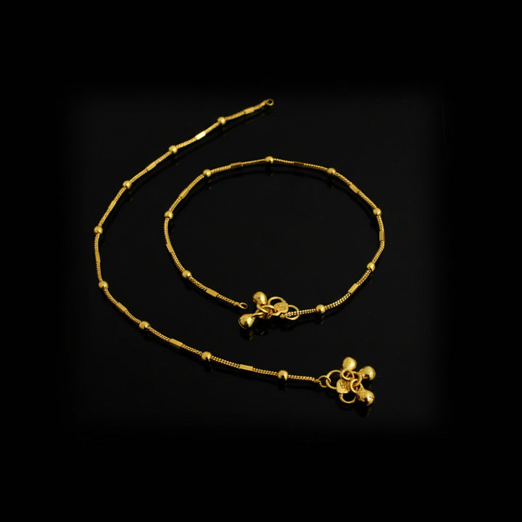 Gold anklets on a black background