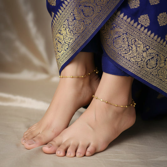Gold anklet on a black background