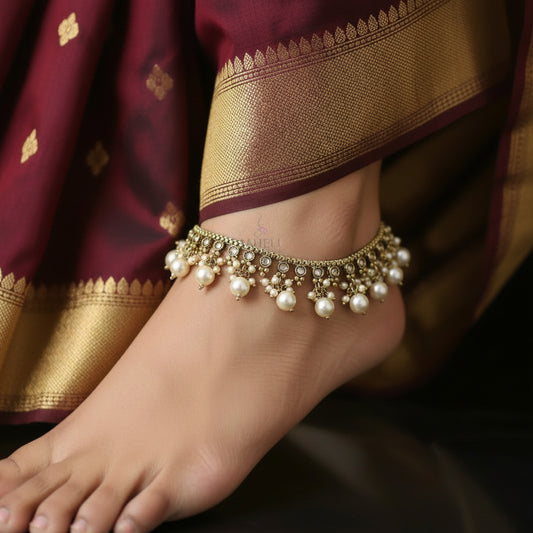 Gold and pearl necklace with 'Saheeli' brand logo on a dark background