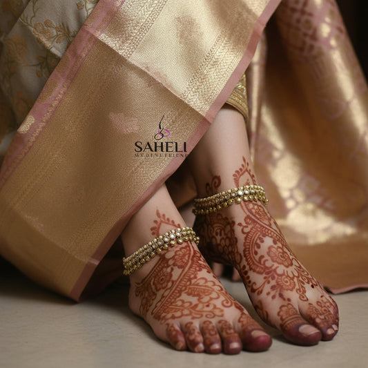Gold necklace and bracelet set with 'Saheli' branding on a dark background
