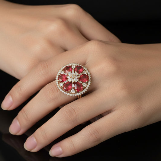 Ring with red gemstones and diamond-like elements on a black glove against a dark background