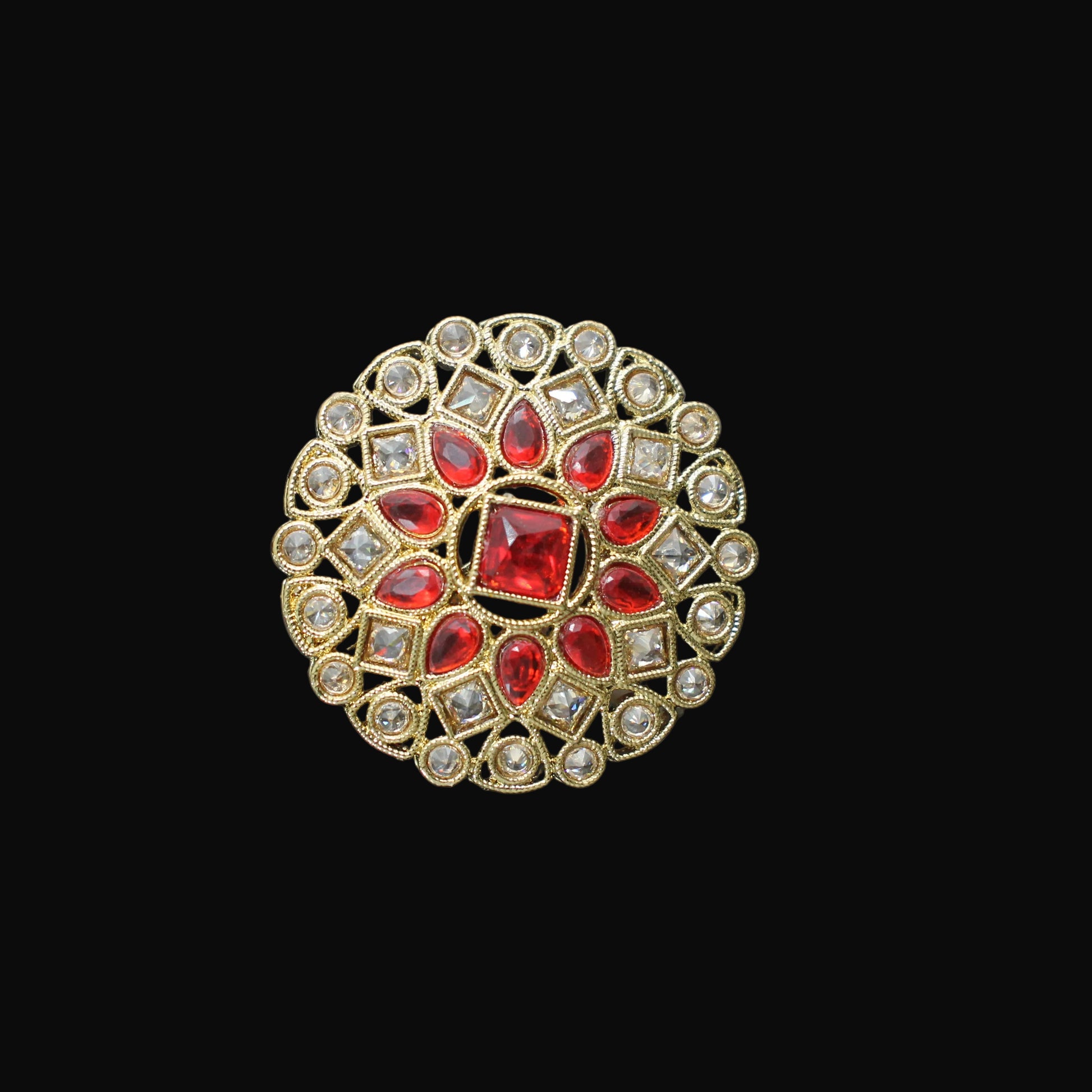Decorative ring with red gemstones and gold accents on a black mannequin hand.