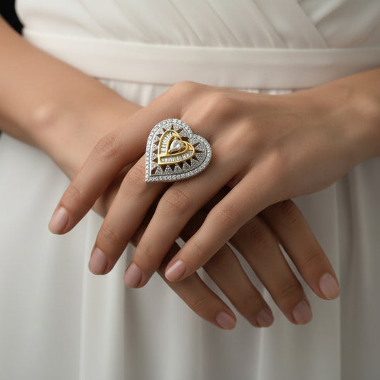 Gold and silver ring on a black hand with 'SAHELI' branding.