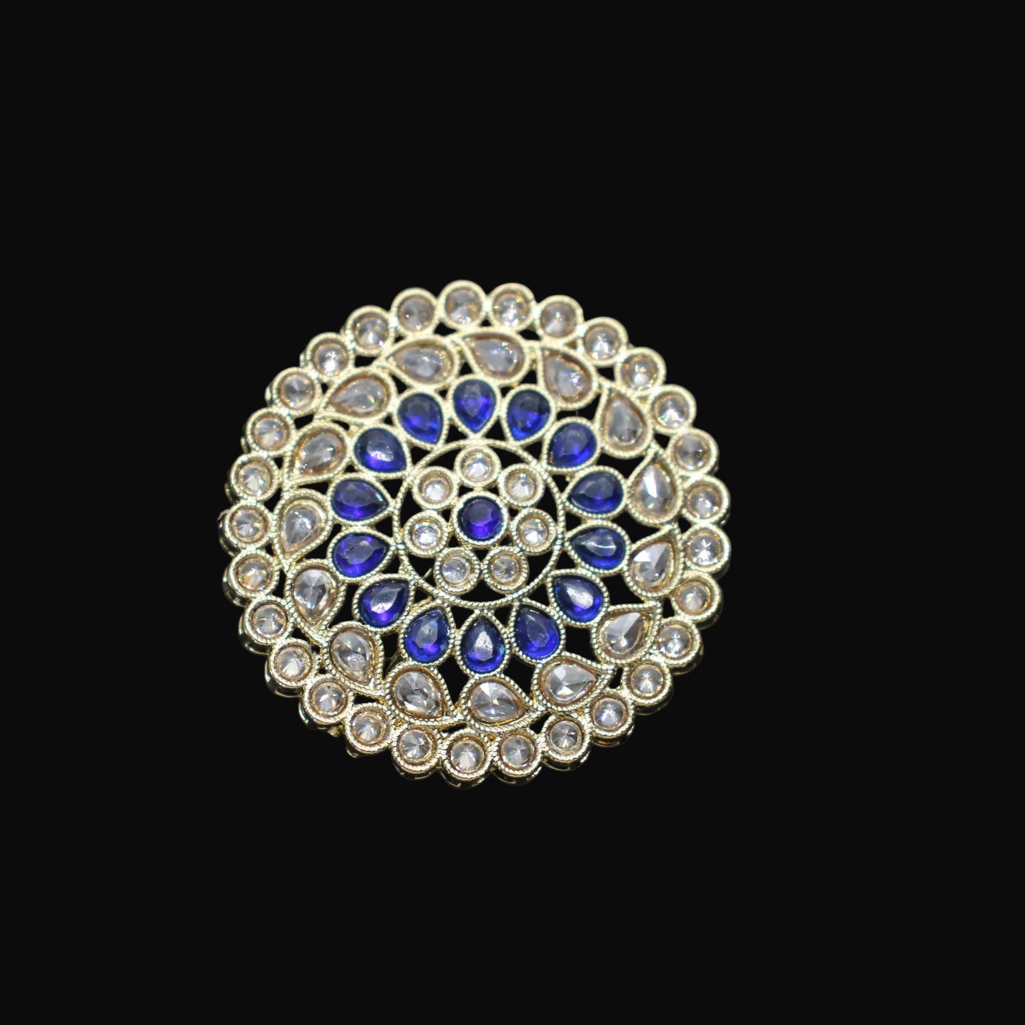 Jewelry ring with blue and clear gemstones on a black mannequin hand