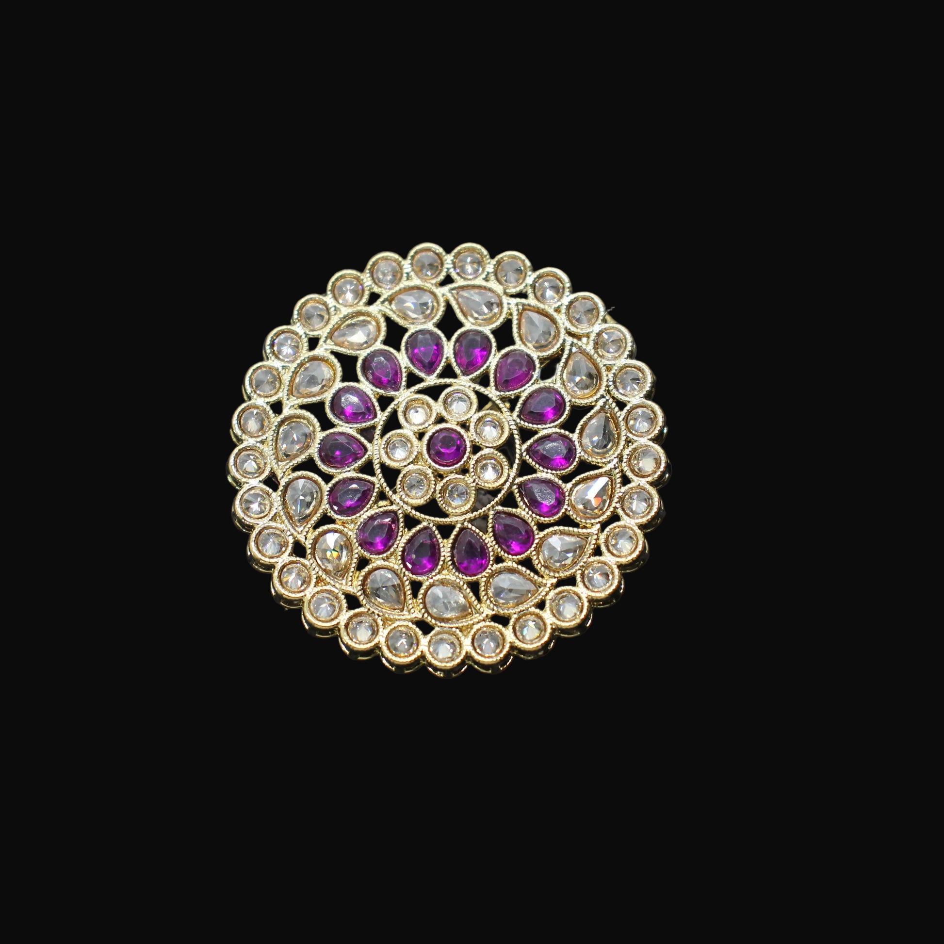 Gold ring with purple gemstones on a black mannequin hand