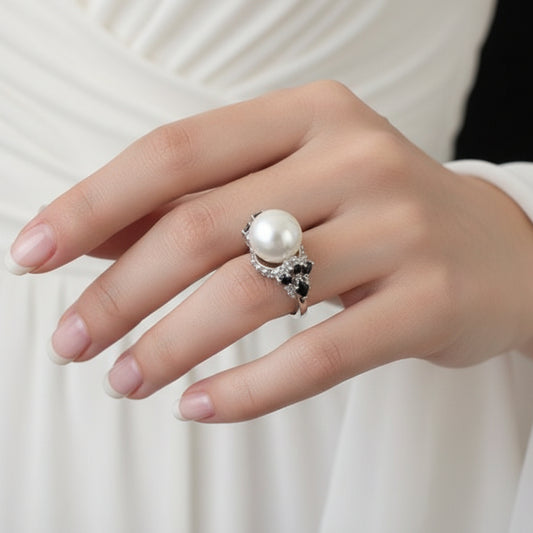 Pearl ring on a black mannequin hand with 'SAHELI' branding.
