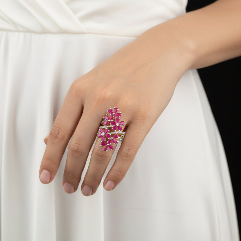 Jewelry with pink flowers on a gray background, featuring the brand 'Saheli'.