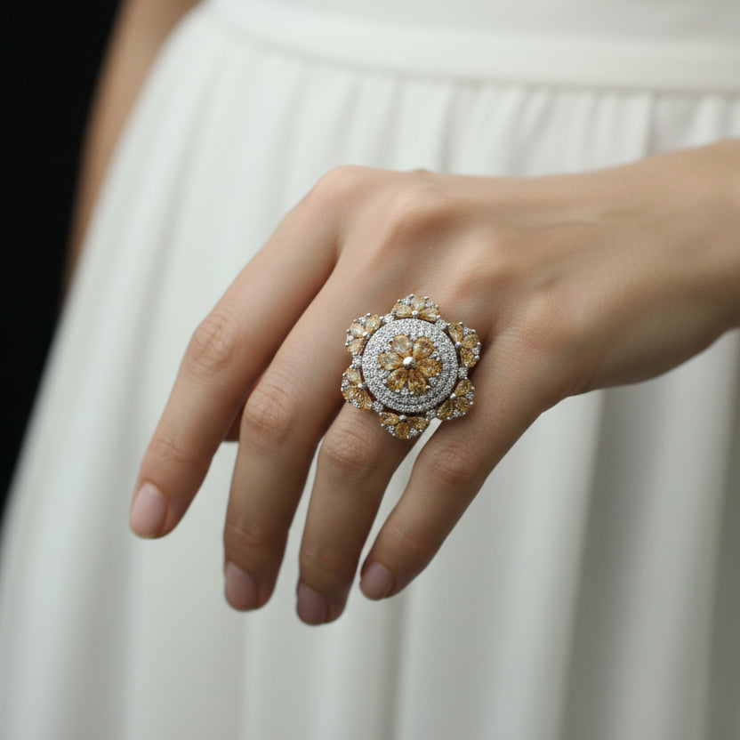 Decorative brooch with gemstones on a dark background, featuring the 'Saheli' brand.