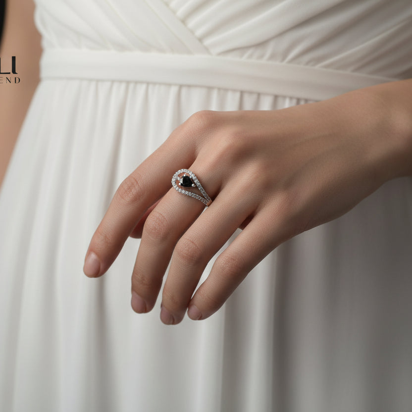 Pavé diamond ring on a hand wearing a black glove with 'SAHELI' branding.