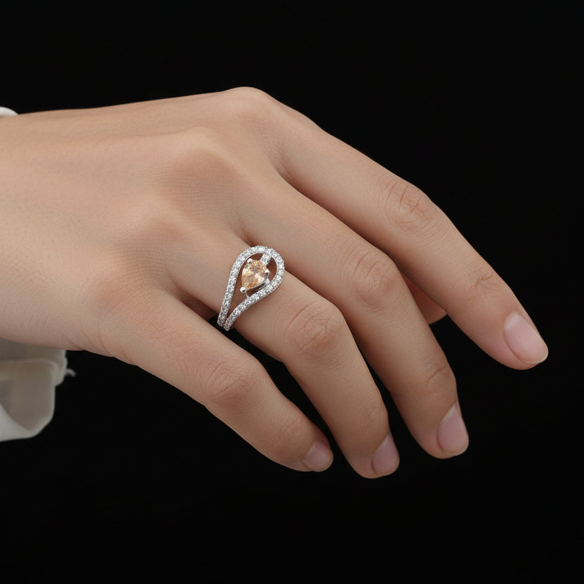 Diamond ring with a central yellow gemstone on a black background, featuring the brand 'Saheli'.
