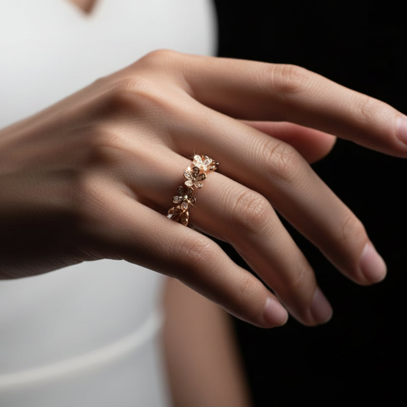 Gold ring with small stones on a black mannequin hand