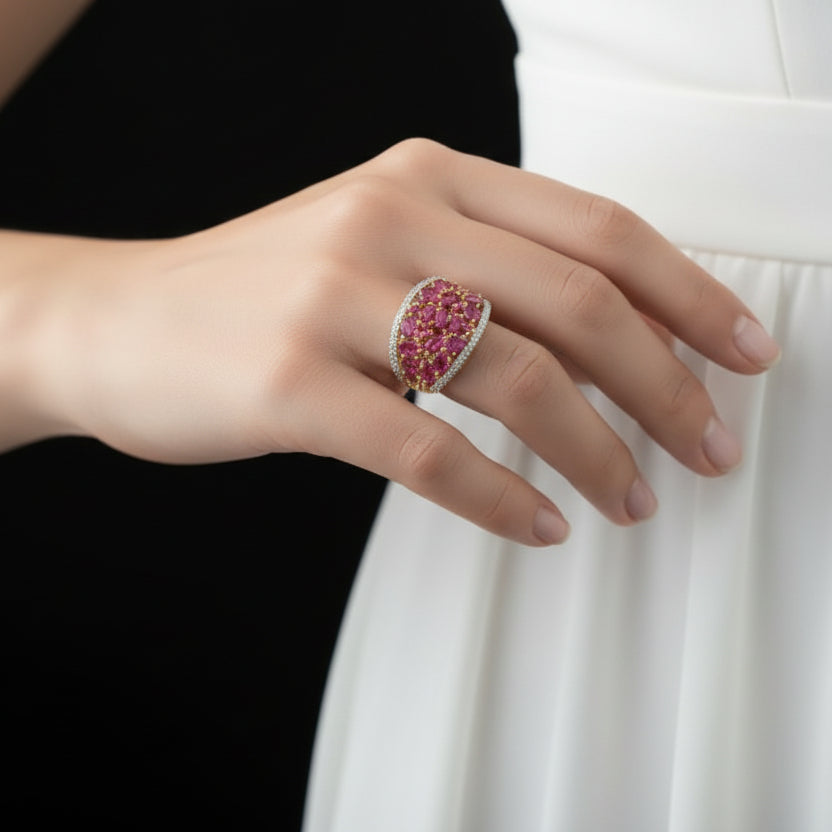 Jewelry ring with pink gemstones on a black glove, brand 'SAHEL' visible.