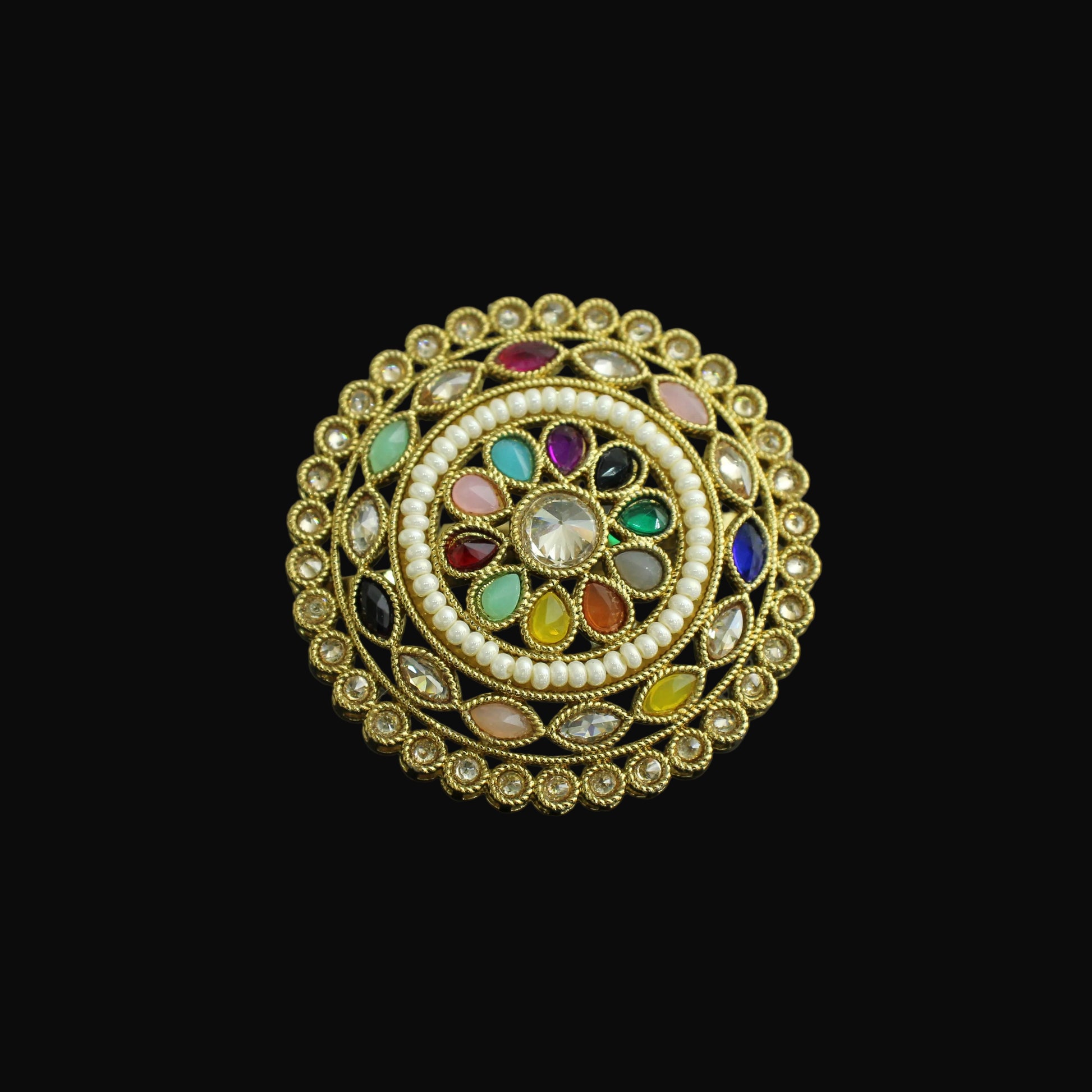 Decorative ring with colorful gemstones on a dark background