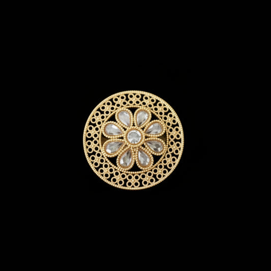 Gold ring with intricate design on a black mannequin hand