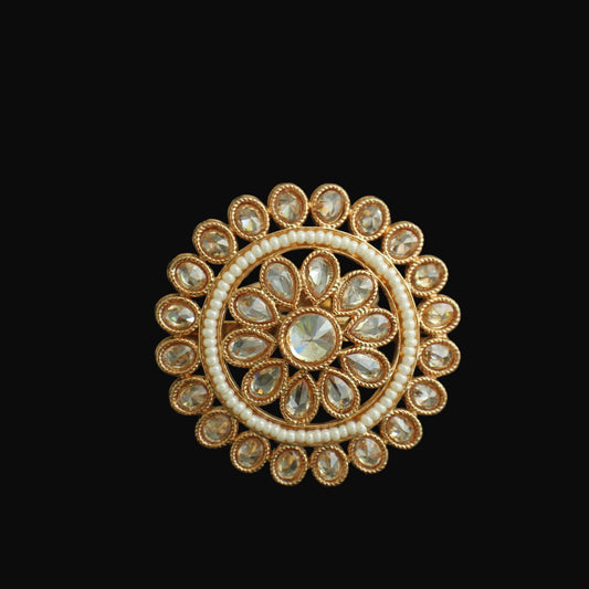Decorative ring with gold and gemstone design on a black background