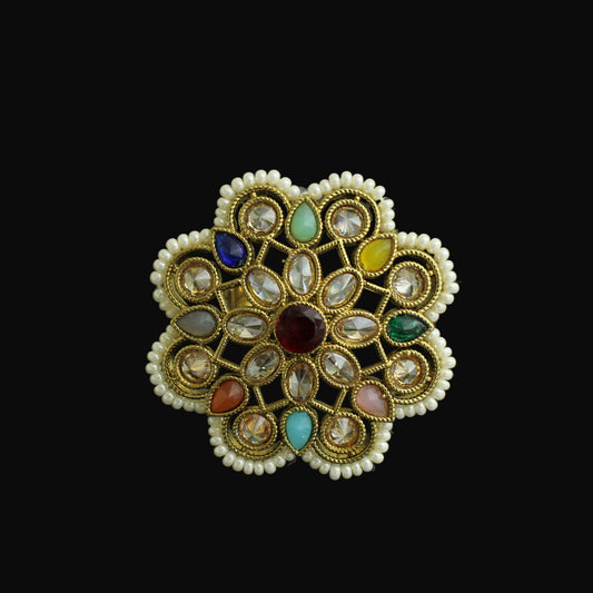 Decorative ring with multicolored gemstones on a dark background
